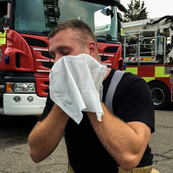 man cleaning face after fire